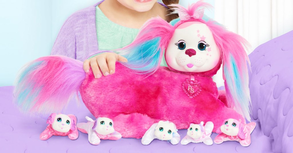 girl playing with pink dog plush and puppies toy