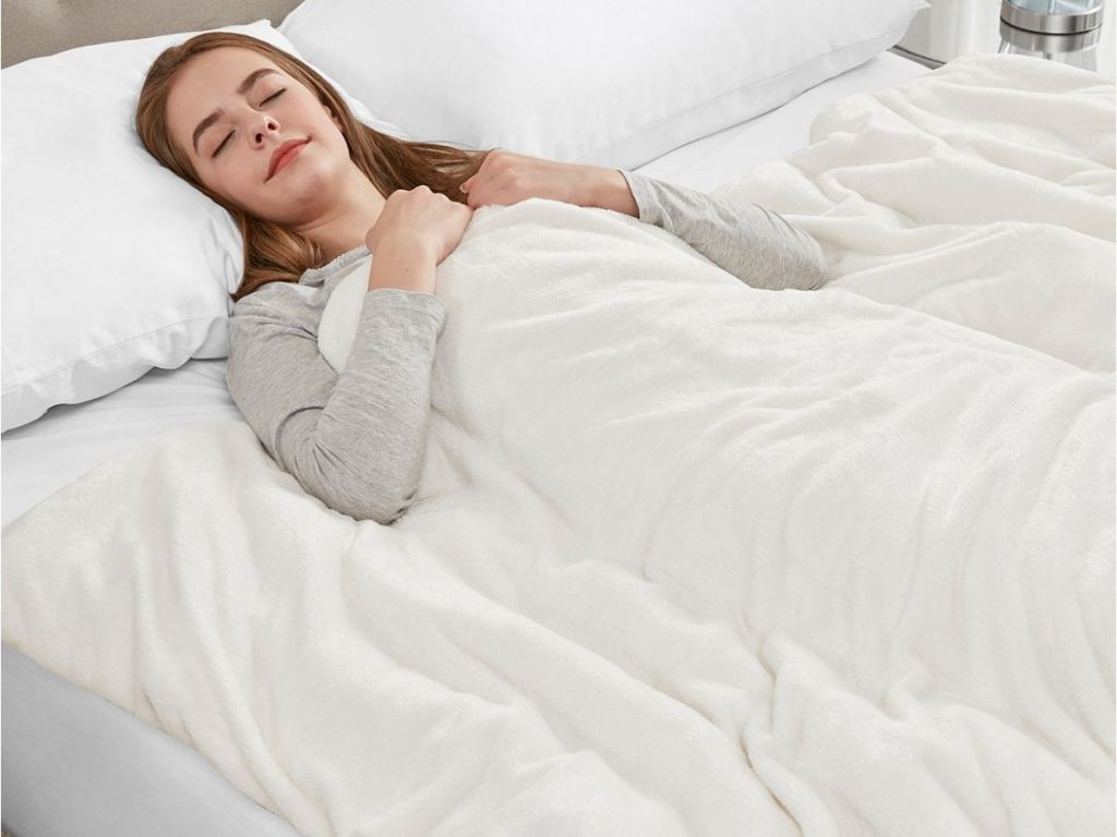 woman wleeping under plush blanket