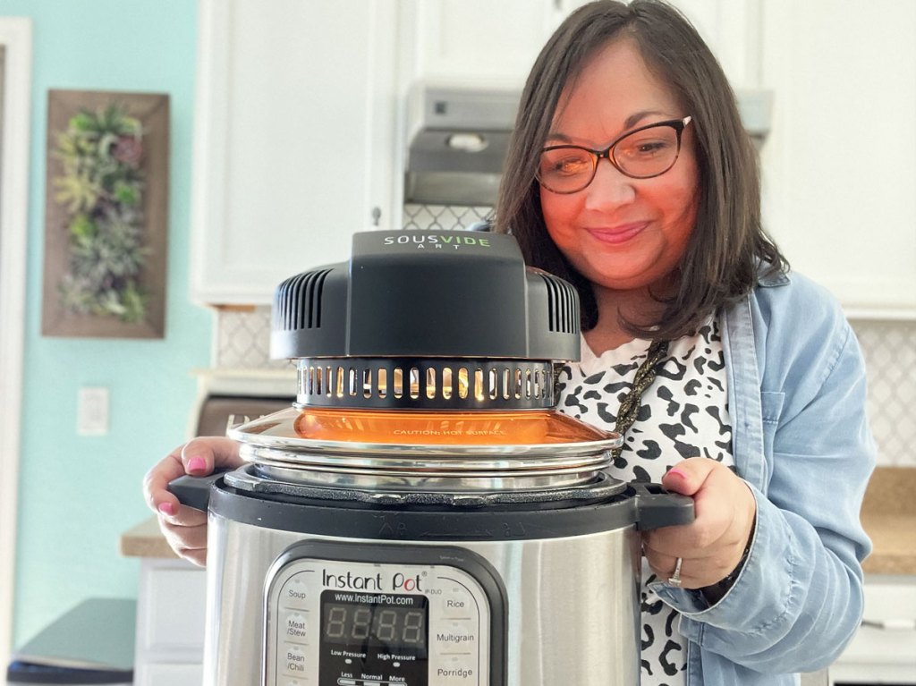 woman watching air fryer lid on an instant pot