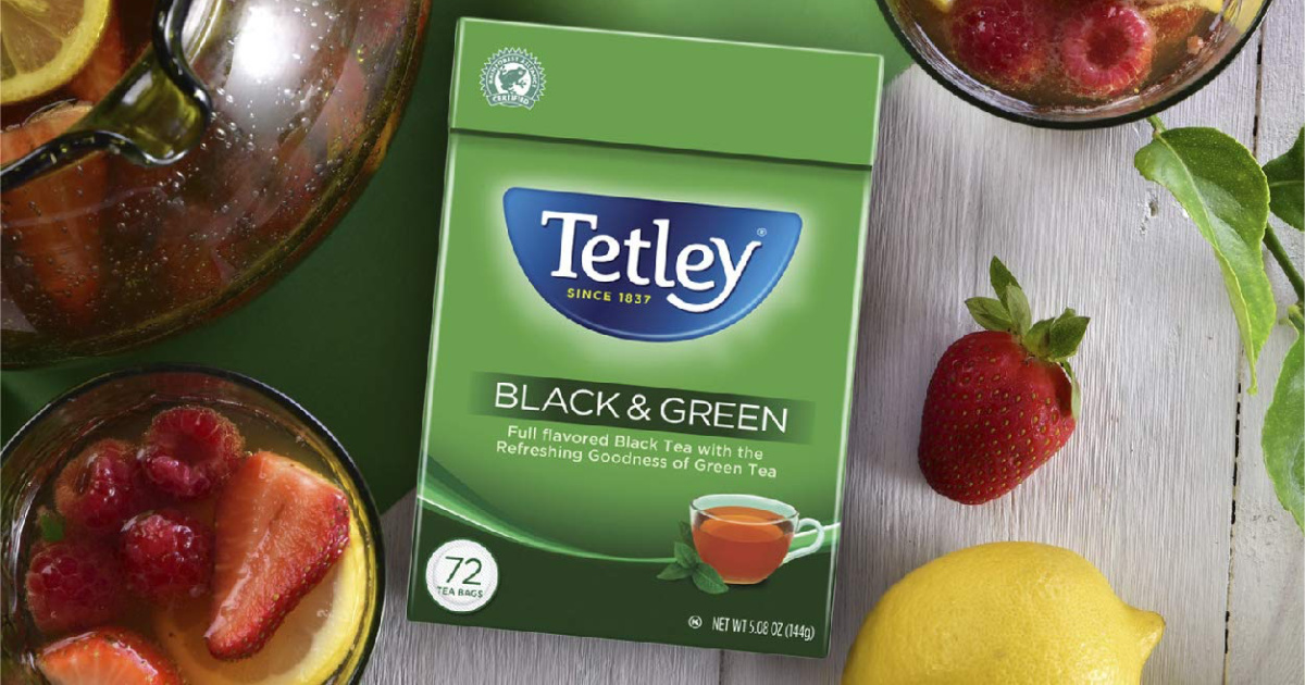 Tetley Black & Green Tea on table among fruit