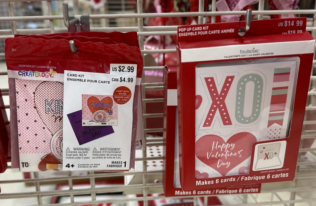 two valentines day card kits on store display rack
