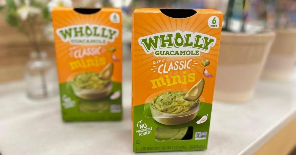 two boxes of wholly guacamole mini cups in store