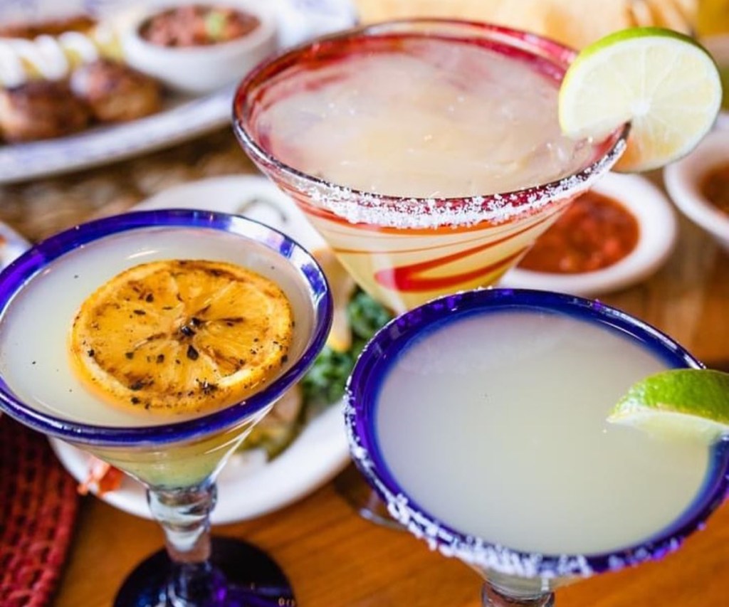3 margaritas garnished with different citrus fruits