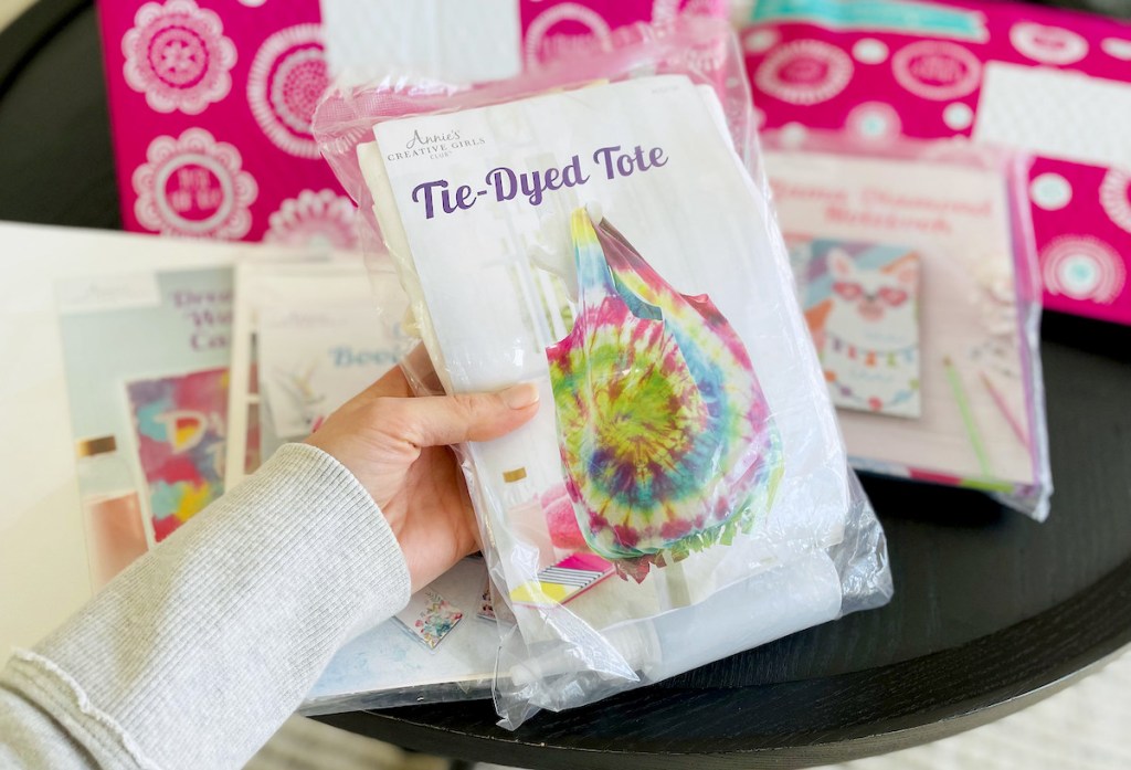 hand holding a tie dyed bag craft kit