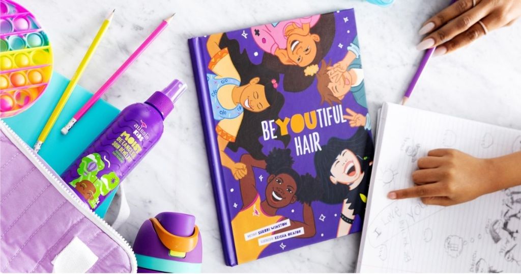 BeYoutiful Hair book on table with pencils, hair styling spray and notebooks