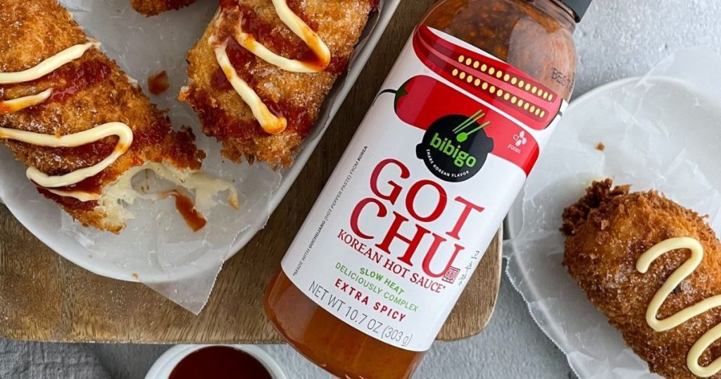Bibigo GOTCHU hot sauce with food around bottle