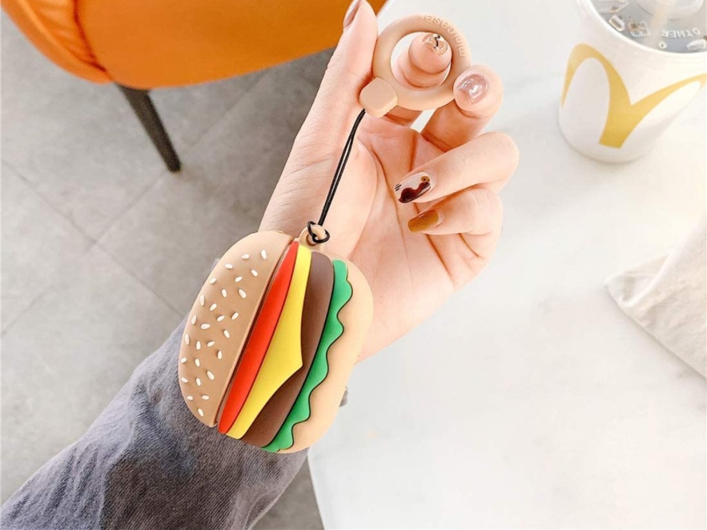holding an AirPods Pro case that's shaped like a cheeseburger