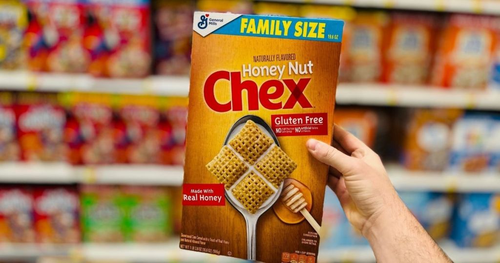 hand holding Chex Honey Nut cereal 