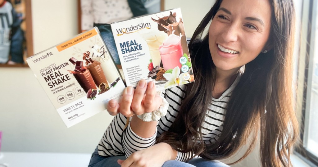 woman holding two boxes of meal replacement shakes