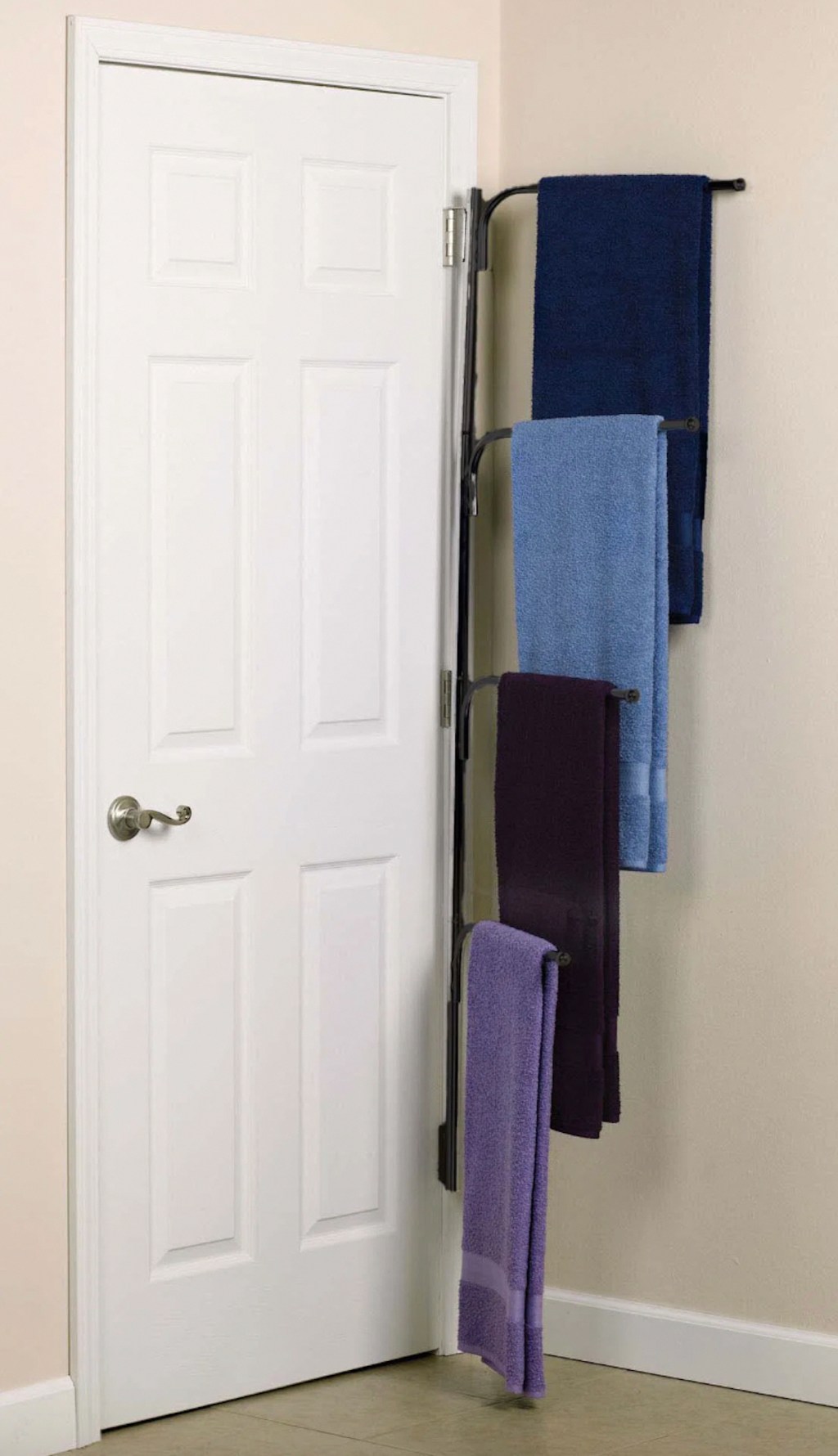 bronze towel rack on white door 