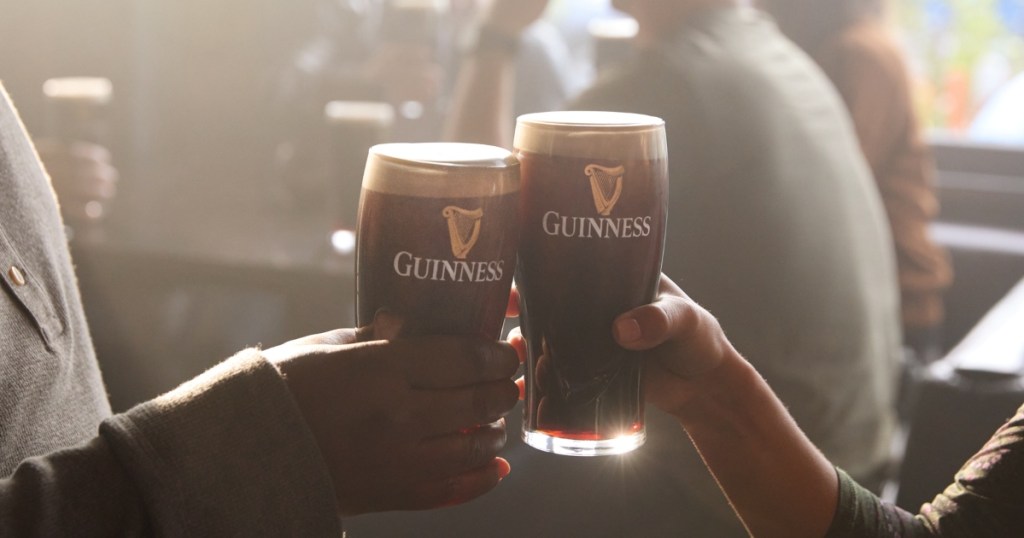 toasting with two glasses of Guinness