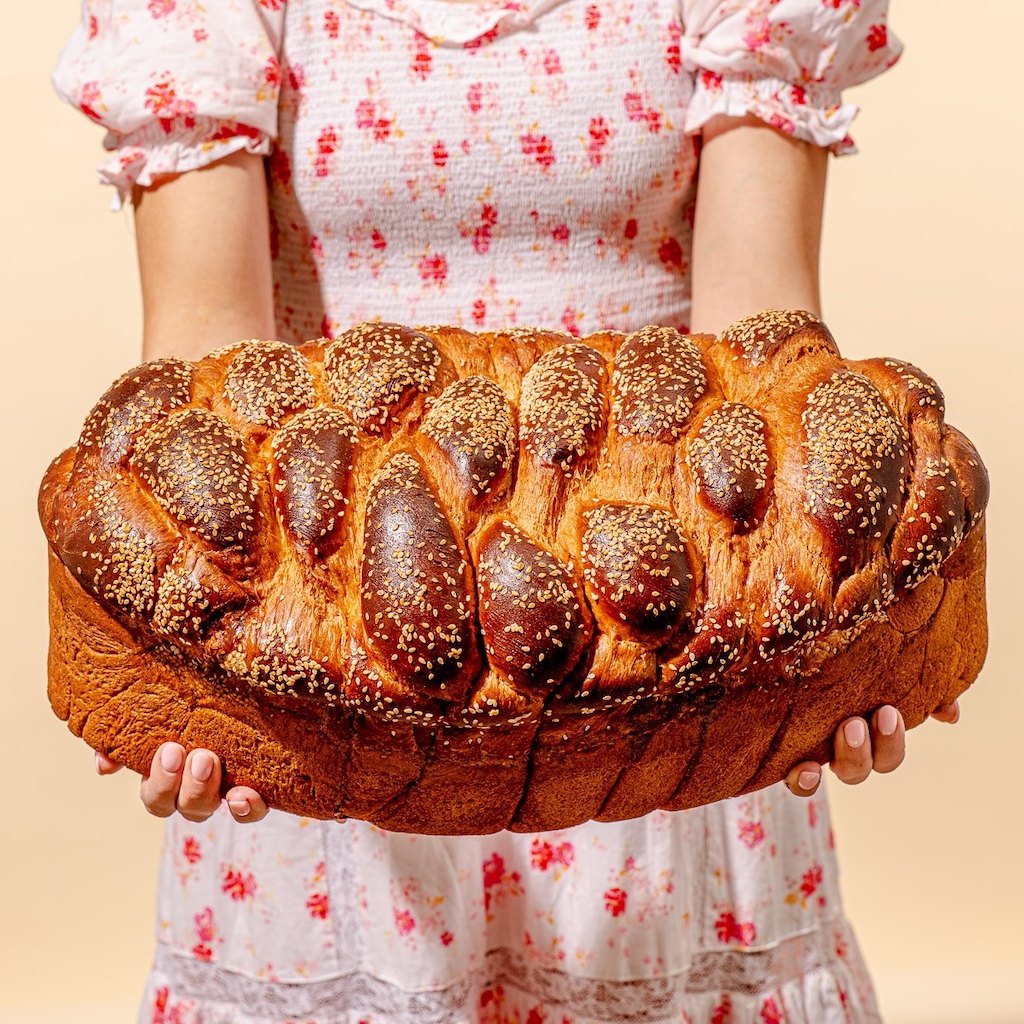 Holding super large loaf of bread 