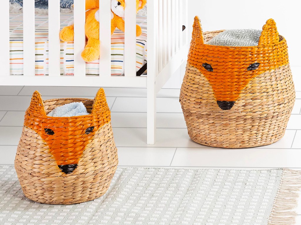 two fox shaped baskets next to crib