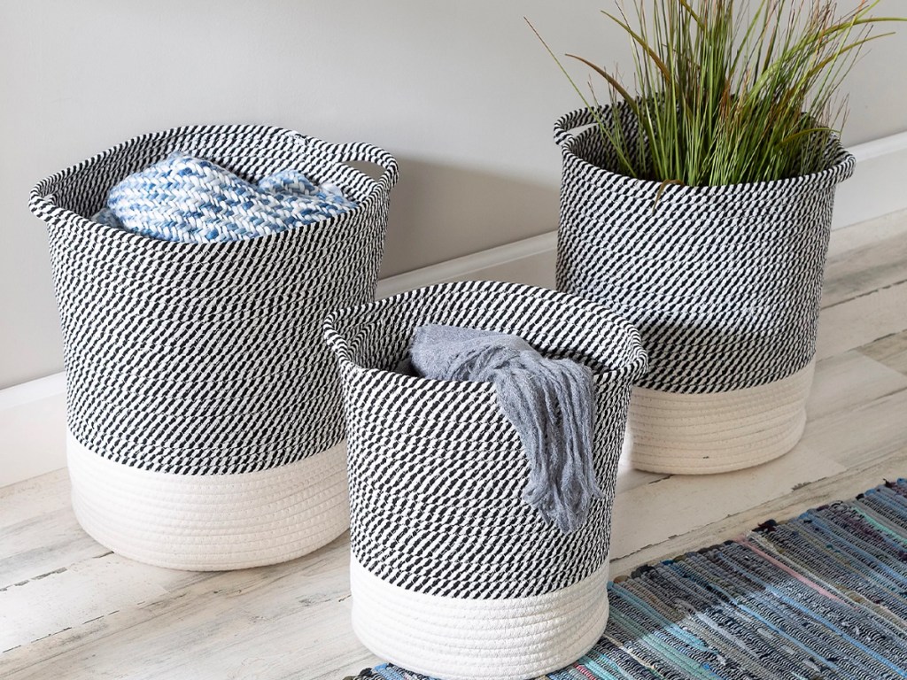blue and white striped rope baskets with blankets and plants inside