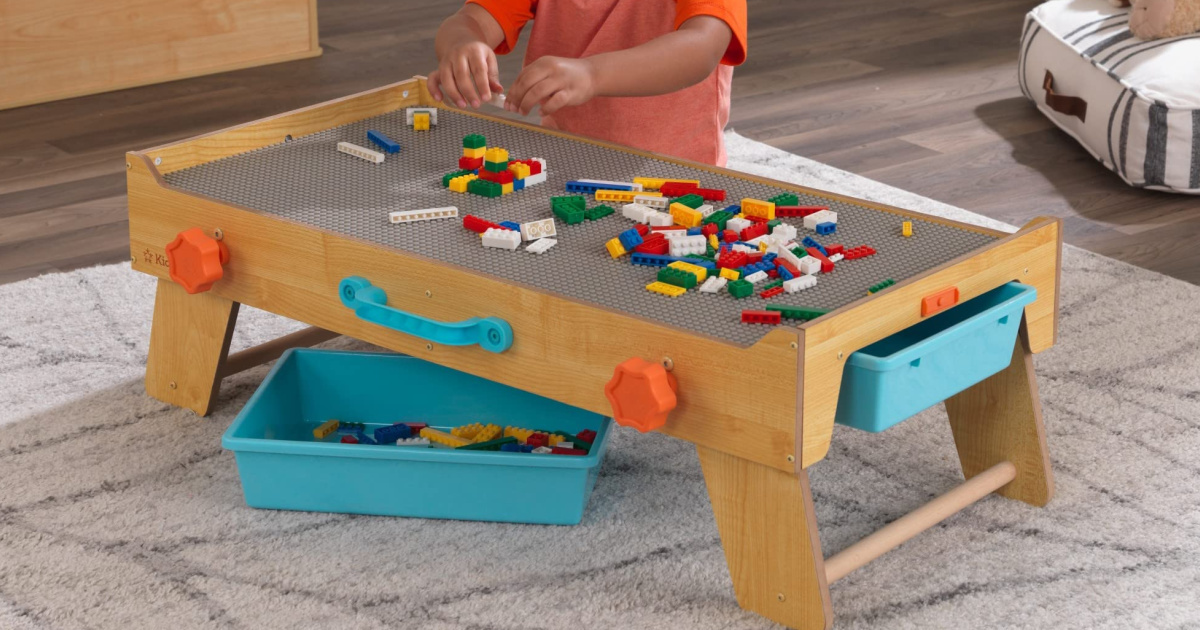boy playing while using a LEGO table