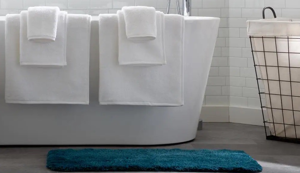 Linenspa white towels hanging over bath