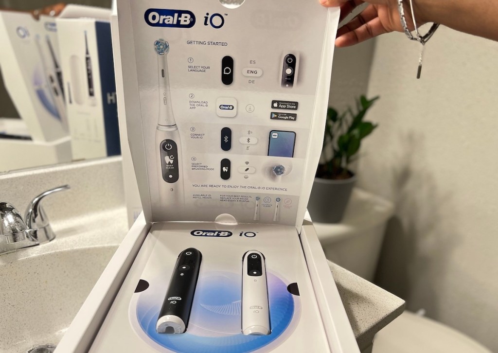 hand holding open box to oral b toothbrush costco