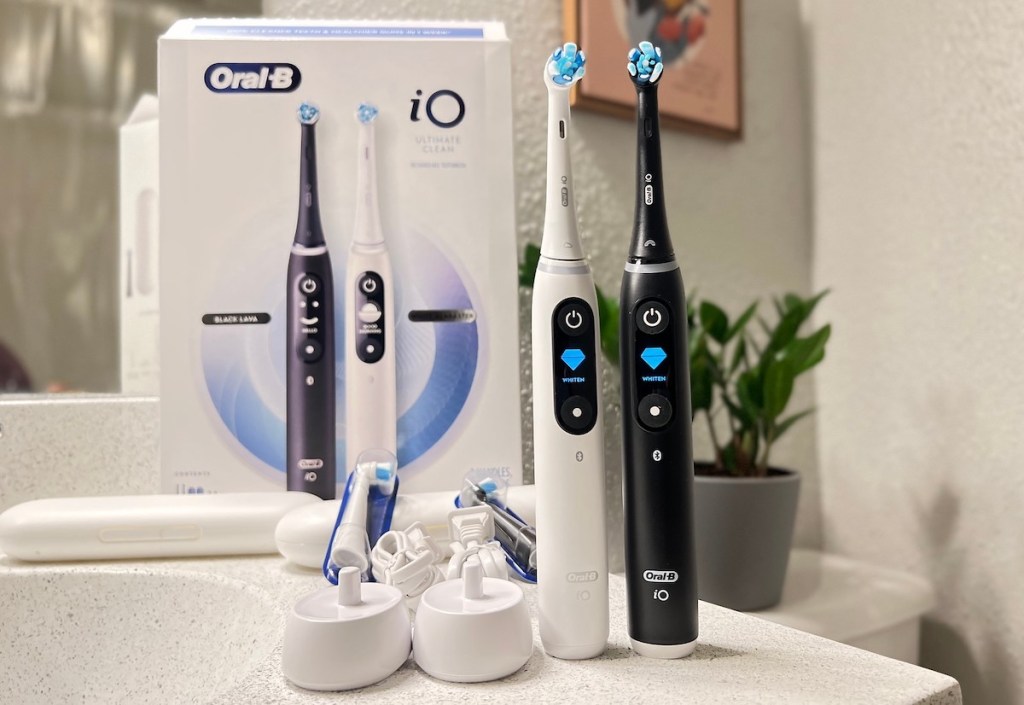 black and white oral b toothbrushes on bathroom countertop
