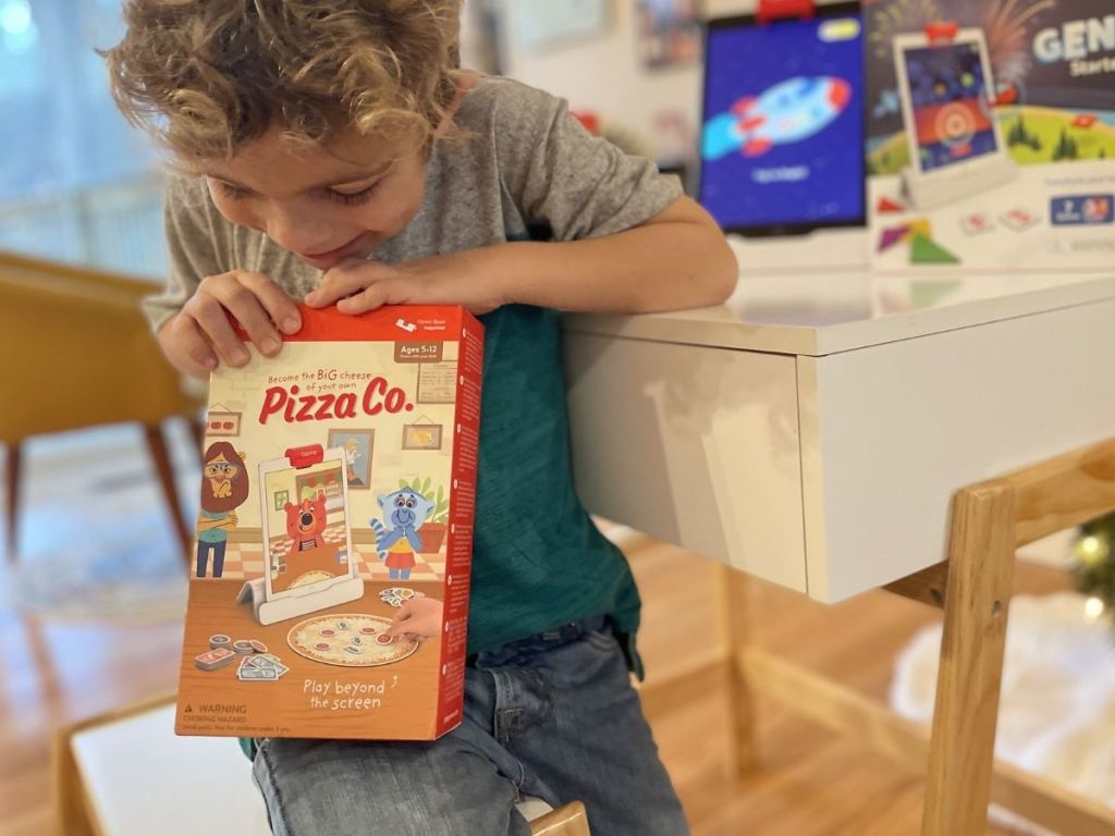 boy holding Osmo Pizza Co. kit