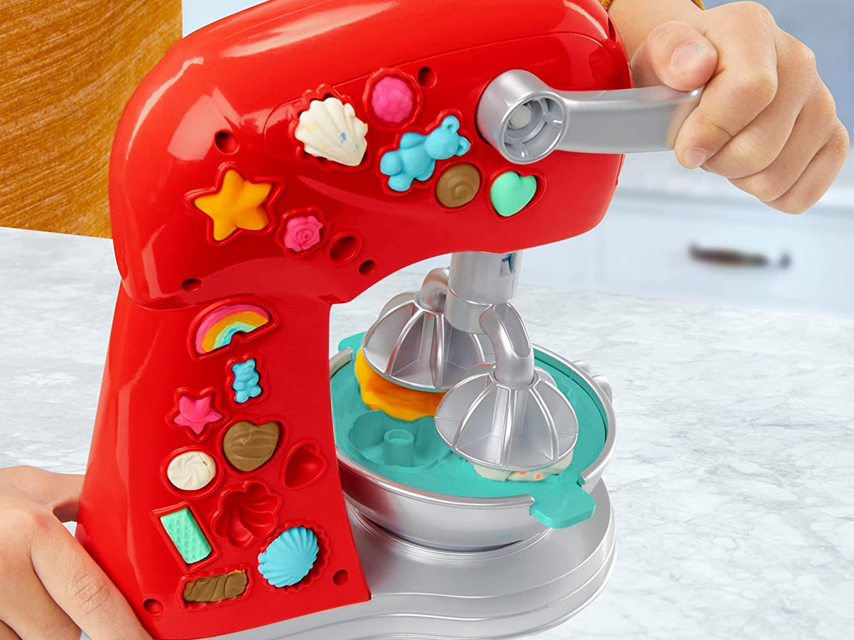 child playing with playdoh baking kit