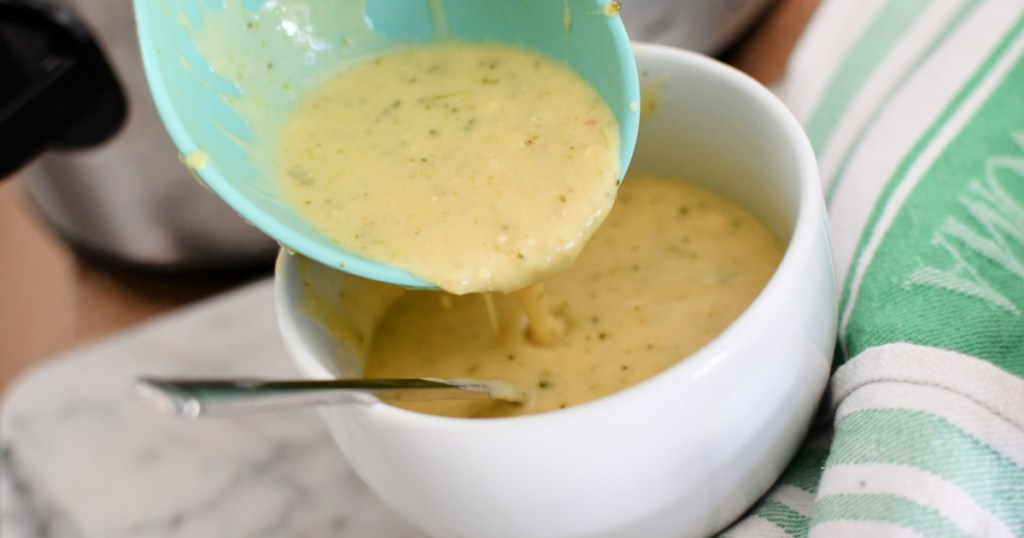 pouring a bowl of broccoli cheddar soup