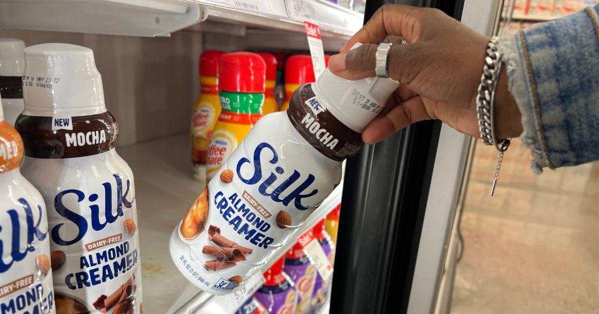 hand grabbing Silk Almond Creamer from store refrigerator