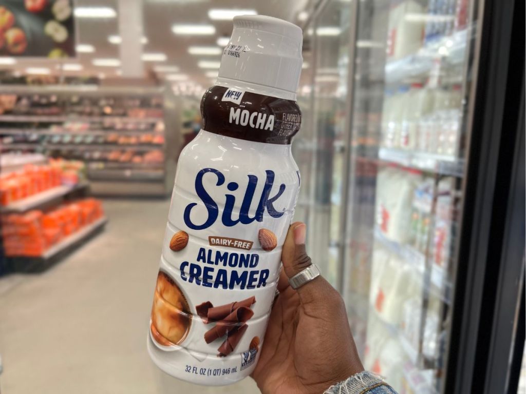 hand holding Silk Mocha Almond Creamer