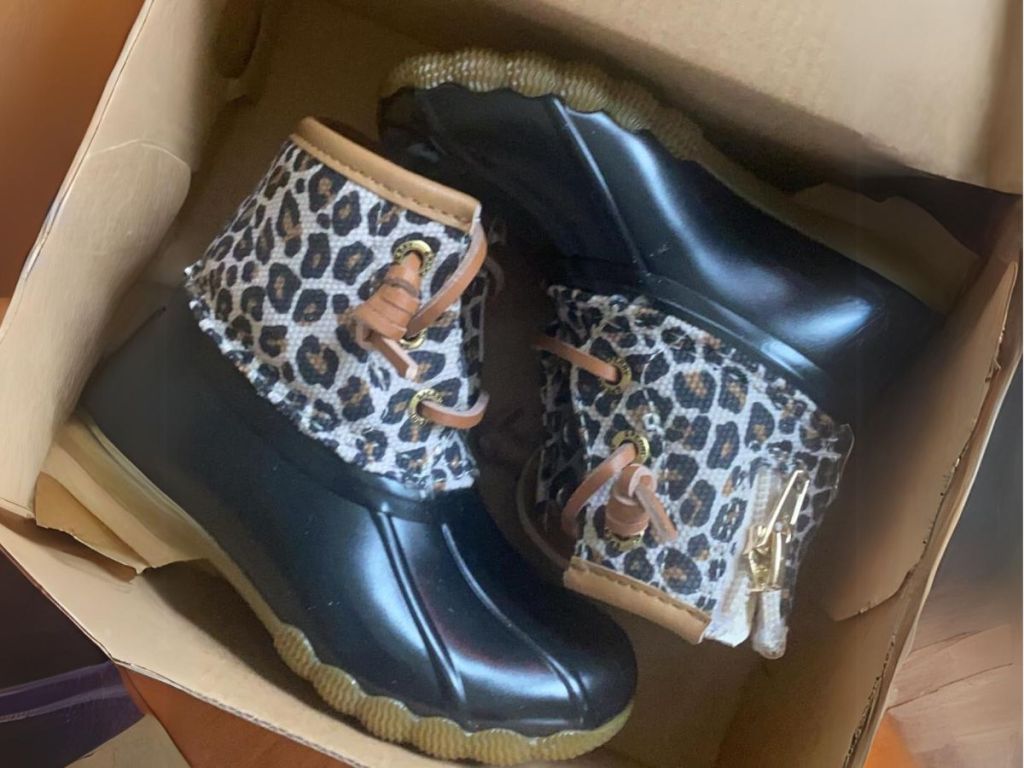pair of animal print and black Sperry duck boots in box