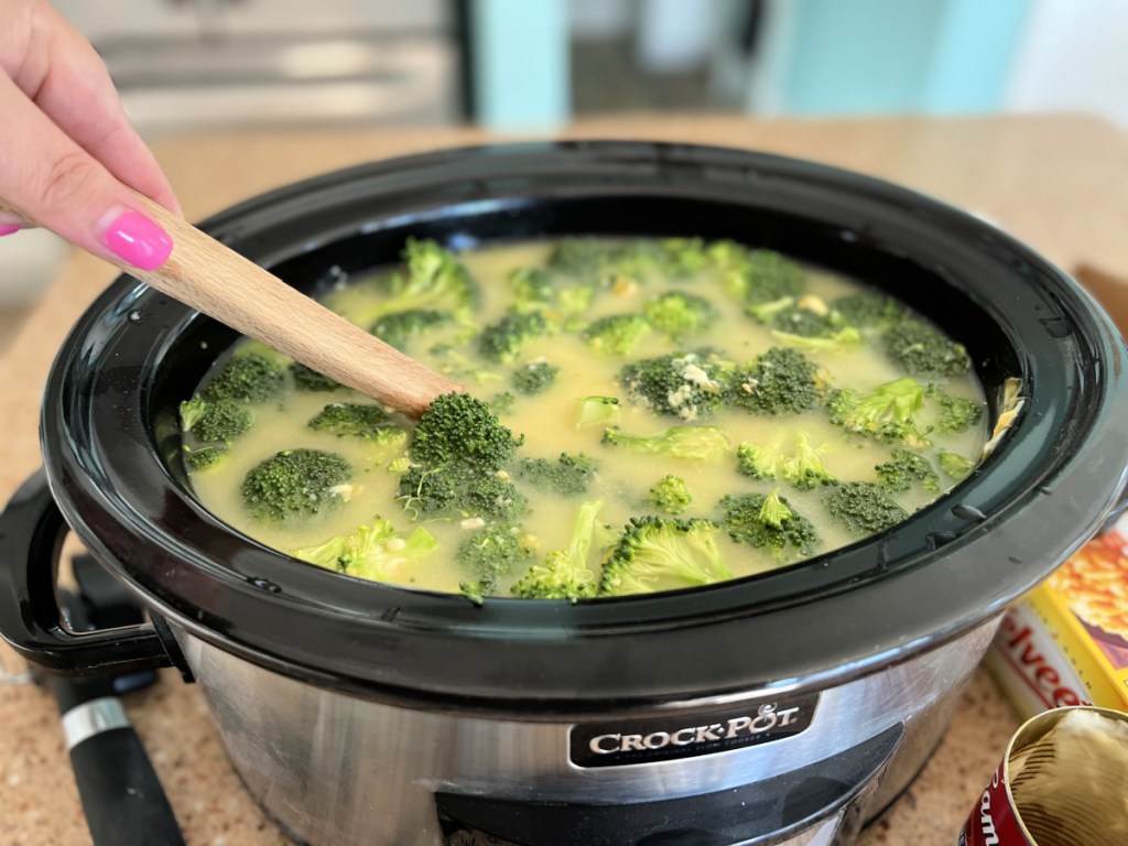 stirring broccoli cheddar soup