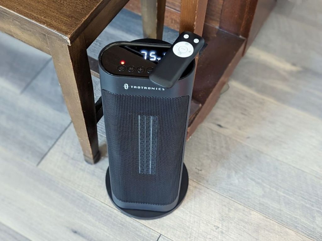 TaoTronics Oscillating Portable Space Heater and remote placed on hardwood floor
