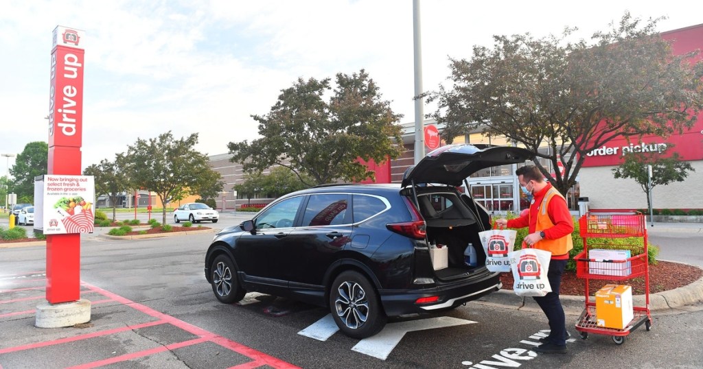 Target employee adding bags to trunk of black vehicle