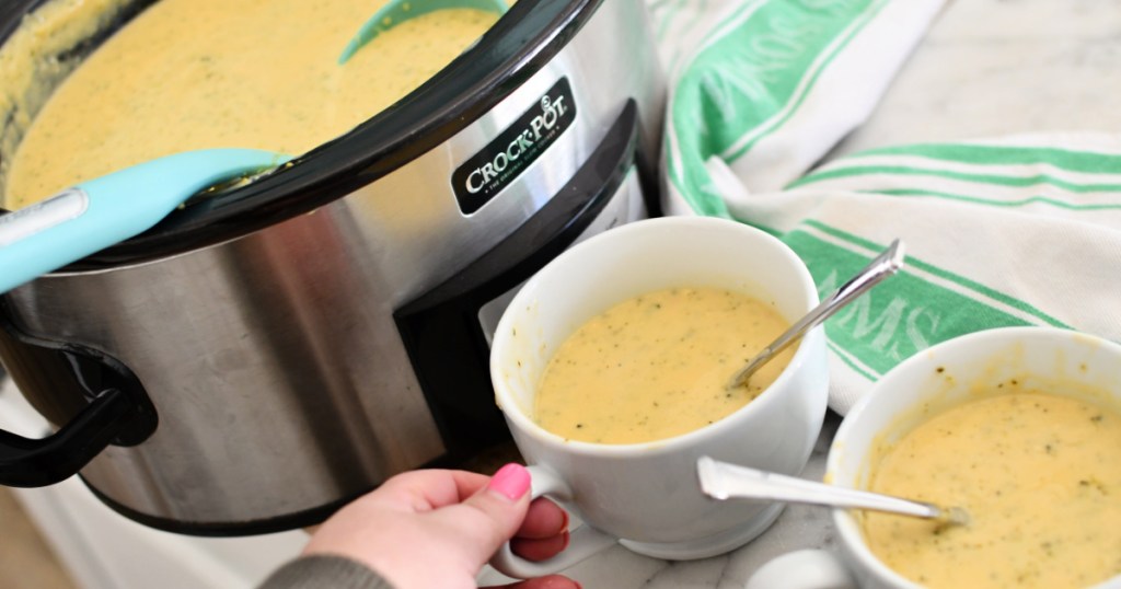 two bowls of broccoli cheddar soup next to Crock-Pot