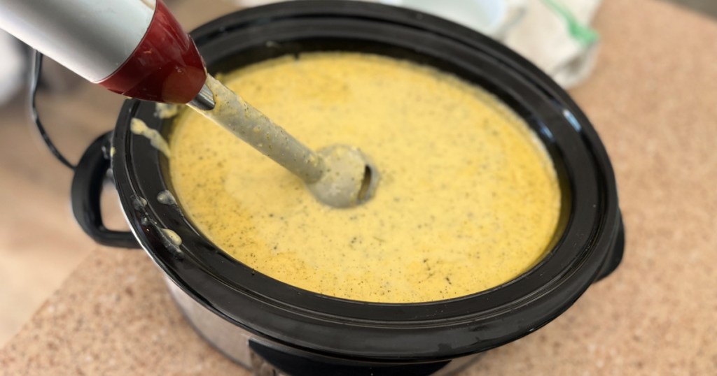 using a hand blender on broccoli cheddar slow cooker soup