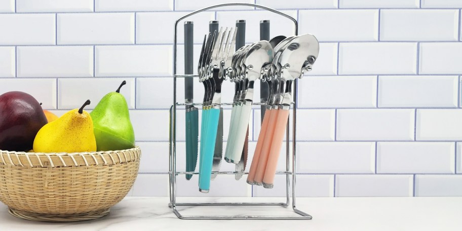 blue, white, and pink flatware in storage on counter