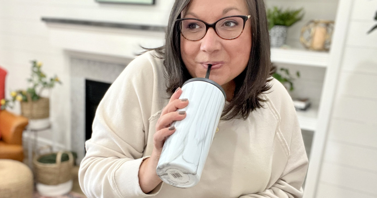 woman drinking from tumbler