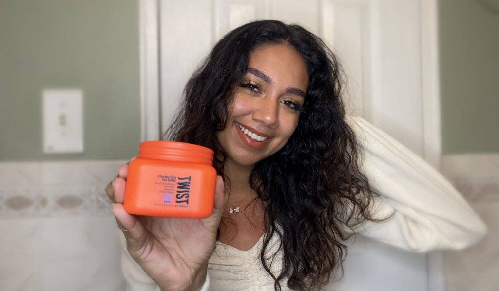 woman holding twist strengthen the bond hair mask for curly hair