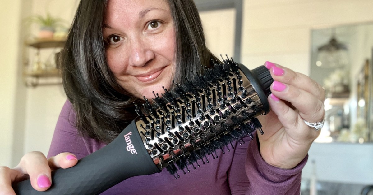 woman holding l'ange le volume dryer brush