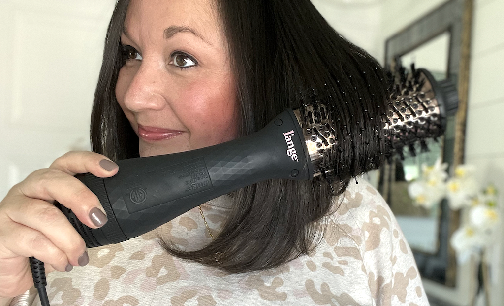 woman using l'ange blow dryer brush