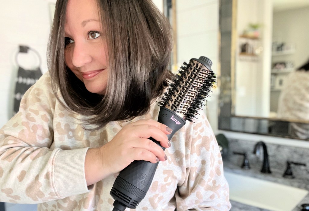 woman using l'ange hair dryer brush