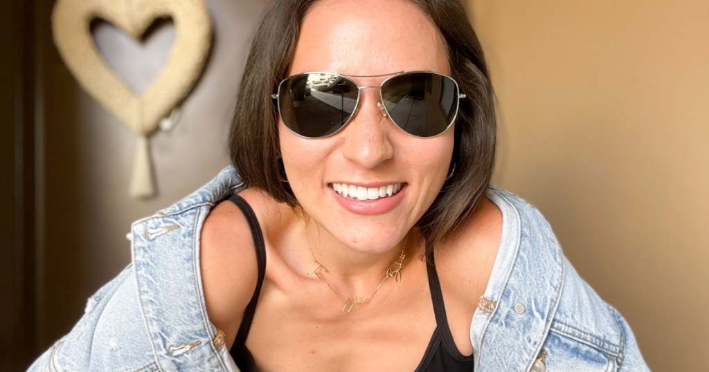 woman in jean jacket wearing sunglasses