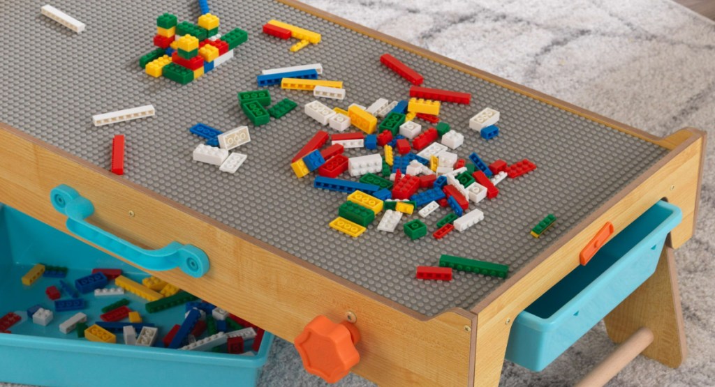 wood activity table with legos on it