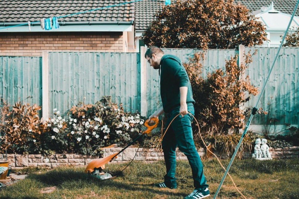 man using a weed trimmer
