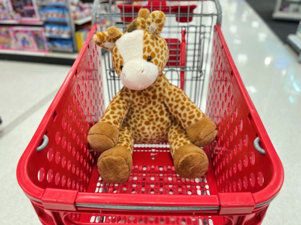 plush giraffe in a cart