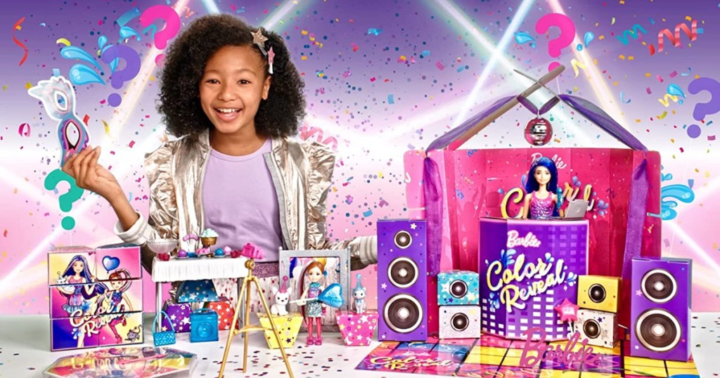 Girl displaying all pieces in Barbie Color Reveal Party set