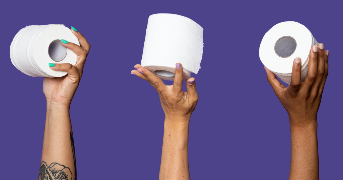 three women's hands holding up rolls of toilet paper