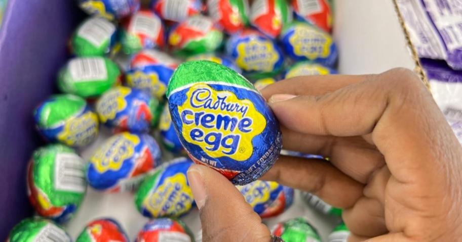 hand holding a cadbury creme eggs in store