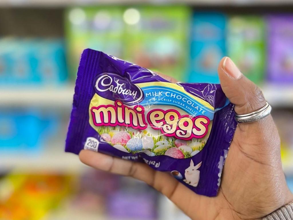 hand holding bag of cadbury mini eggs in store