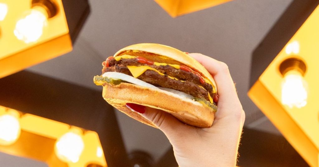 Hand holding up a Carl's Jr. Double Cheeseburger