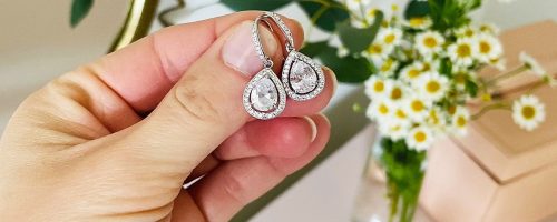 hands holding pair of cate & chloe earrings