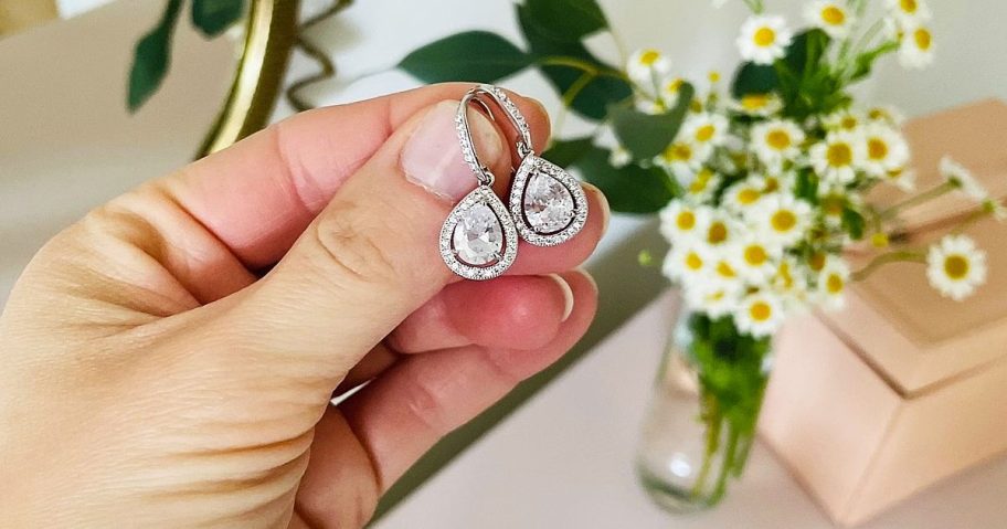 hands holding pair of cate & chloe earrings